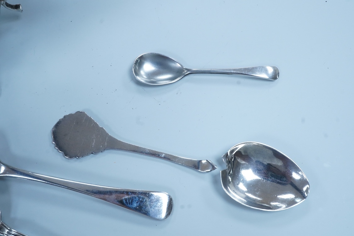 A pair of George VI silver sauceboats, with scroll handles, Stokes & Ireland, 1936, 16.2cm, together with four silver tennis related teaspoons (1 a.f.) and two small silver condiment spoons.